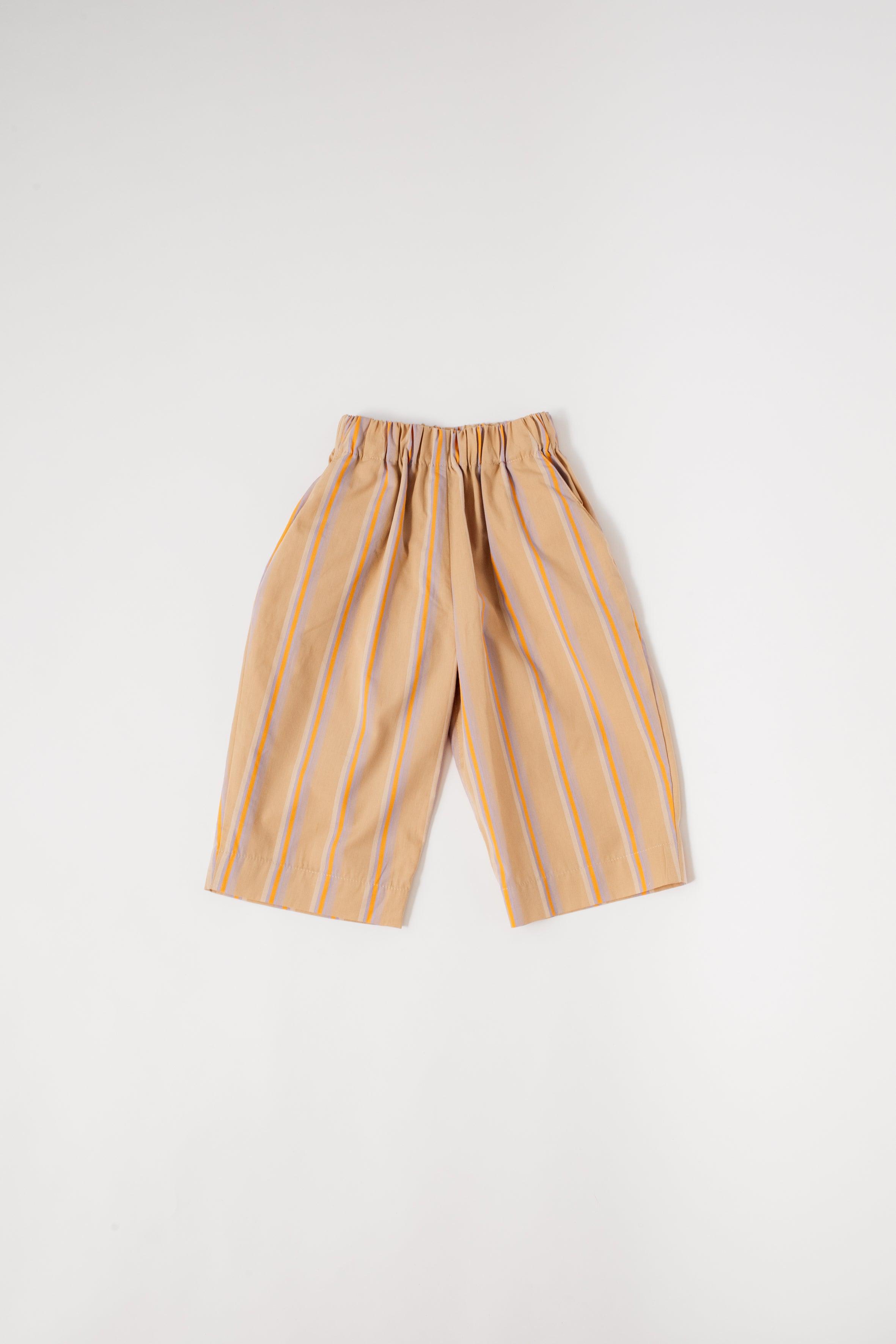 Modern and comfy straight leg striped trousers with elasticated waistband and slanted side pockets, patch pocket in the back. Made from a soft, washed organic cotton, beige base with lilac and orange yarn-dyed stripe. Matching woven t-shirt and romper available for the perfect kids wedding outfit or holiday look. 100% organic cotton Studio Koter is a UK based unisex kidswear and toddler clothing brand. All garments are produced in the UK and Portugal in a considered and sustainable way.